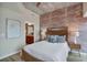 Bedroom with exposed brick wall and hardwood floors at 777 N Ashley Dr # 2612, Tampa, FL 33602