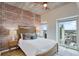 Bright bedroom with brick feature wall, city view, and modern furnishings at 777 N Ashley Dr # 2612, Tampa, FL 33602