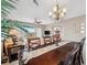 Elegant dining room with dark wood table, chandelier, and view into living room at 960 Starkey Rd # 2501, Largo, FL 33771