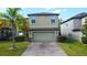 Two-story home with a two-car garage and brick driveway at 20028 Satin Leaf Ave, Tampa, FL 33647