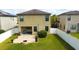 Aerial view of a backyard with a patio, fire pit, and fenced area at 20028 Satin Leaf Ave, Tampa, FL 33647