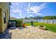 Backyard patio with fire pit and well-manicured lawn at 20028 Satin Leaf Ave, Tampa, FL 33647