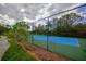 Blue tennis court surrounded by a chain link fence at 20028 Satin Leaf Ave, Tampa, FL 33647