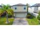 Two-story house with a two-car garage and a landscaped lawn at 20028 Satin Leaf Ave, Tampa, FL 33647