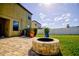 Spacious backyard with fire pit, patio, and fenced yard at 20028 Satin Leaf Ave, Tampa, FL 33647