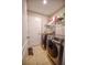 Bright laundry room with washer, dryer, and ample shelving at 20028 Satin Leaf Ave, Tampa, FL 33647