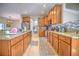 Kitchen boasts granite countertops, ample wood cabinetry, and tile flooring at 20028 Satin Leaf Ave, Tampa, FL 33647