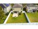 Aerial view showing a house's backyard with a patio, fire pit, and fenced yard at 20028 Satin Leaf Ave, Tampa, FL 33647
