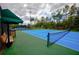 Community tennis court with shaded seating area at 20028 Satin Leaf Ave, Tampa, FL 33647