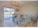 Dining area with a sleek table and chairs, large sliding glass doors, and modern light fixture at 20028 Satin Leaf Ave, Tampa, FL 33647