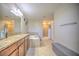Spacious bathroom with granite countertops, a soaking tub, and a separate shower at 20028 Satin Leaf Ave, Tampa, FL 33647