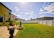 Large backyard with grassy area, fire pit, and patio at 20028 Satin Leaf Ave, Tampa, FL 33647