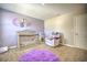 Well-appointed Bedroom with a crib, armchair, and purple rug at 20028 Satin Leaf Ave, Tampa, FL 33647