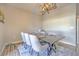 Modern dining room with a dark wood table, light-colored chairs, and stylish chandelier at 20028 Satin Leaf Ave, Tampa, FL 33647