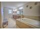 Bathroom with a large soaking tub and double vanity at 20028 Satin Leaf Ave, Tampa, FL 33647