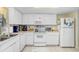 Well-equipped kitchen with white cabinets and appliances at 3789 46Th Ave # 205, St Petersburg, FL 33711