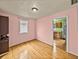 Pink dining room with hardwood floors and kitchen view at 3908 W North B St, Tampa, FL 33609