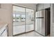 Kitchen features stainless steel refrigerator and sliding glass doors to a patio at 4152 55Th N Way # 1028, Kenneth City, FL 33709