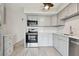 Modern kitchen with stainless steel appliances and white shaker cabinets at 4152 55Th N Way # 1028, Kenneth City, FL 33709
