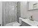 Updated bathroom with grey tiled shower and vanity at 4152 55Th N Way # 1028, Kenneth City, FL 33709