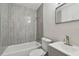 Updated bathroom with gray tile shower/tub combo at 4152 55Th N Way # 1028, Kenneth City, FL 33709