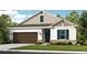One-story home with brown garage door and teal shutters at 5107 Slate Hue Pl, Apollo Beach, FL 33572