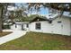 Charming ranch-style home with modern updates and a white fence at 530 Locklie St, Dunedin, FL 34698