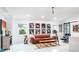 Living area with leather sofa, mid-century modern coffee table, and gallery wall at 530 Locklie St, Dunedin, FL 34698