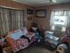 Cozy living room features a recliner, a sofa and a window at 5748 Montana Ave, New Port Richey, FL 34652