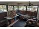 Screened porch with a table, chairs, and various items at 5748 Montana Ave, New Port Richey, FL 34652
