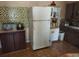 Kitchen area with refrigerator and wood cabinets at 5748 Montana Ave, New Port Richey, FL 34652