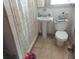 Bathroom with shower/tub combo, toilet, and pedestal sink at 5748 Montana Ave, New Port Richey, FL 34652