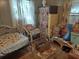 Bedroom with twin bed, wicker chair, and storage boxes at 5748 Montana Ave, New Port Richey, FL 34652