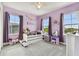 Purple bedroom with two windows, a bed, and a vanity at 6317 Brevada Ln, Apollo Beach, FL 33572