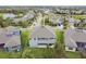 Aerial view of home with fenced backyard, well-manicured lawn, and neighborhood views of nearby pond at 6317 Brevada Ln, Apollo Beach, FL 33572