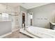 Beautiful bathroom featuring a tiled shower with dual shower heads and a large soaking tub at 6317 Brevada Ln, Apollo Beach, FL 33572