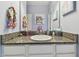 Powder room featuring granite countertop, white sink, and light blue walls at 6317 Brevada Ln, Apollo Beach, FL 33572
