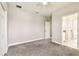 A well lit carpeted bedroom includes a ceiling fan, closet, and attached bathroom at 6317 Brevada Ln, Apollo Beach, FL 33572