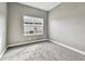Neutral bedroom featuring plush gray carpeting and a bright window at 6317 Brevada Ln, Apollo Beach, FL 33572