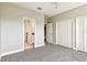 Bedroom featuring neutral carpeting, a ceiling fan and a doorway to the bathroom at 6317 Brevada Ln, Apollo Beach, FL 33572