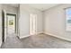 This carpeted bedroom with attached bathroom has two door to access other parts of the home at 6317 Brevada Ln, Apollo Beach, FL 33572