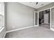 Spacious bedroom with soft grey carpeting and a large window for ample natural light and backyard views at 6317 Brevada Ln, Apollo Beach, FL 33572