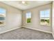 This carpeted bedroom boasts three bright windows, offering plenty of natural light at 6317 Brevada Ln, Apollo Beach, FL 33572