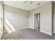 Bedroom with overhead fan, neutral carpet and door leading to bathroom at 6317 Brevada Ln, Apollo Beach, FL 33572