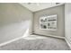 Bedroom features plush carpeting, neutral walls and bright natural light from window at 6317 Brevada Ln, Apollo Beach, FL 33572