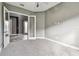 Bright bedroom with neutral walls, plush carpeting, and French doors opening to the home's entry at 6317 Brevada Ln, Apollo Beach, FL 33572