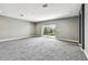 Spacious bonus room with gray carpet and sliding glass doors leading to a balcony at 6317 Brevada Ln, Apollo Beach, FL 33572