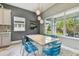 Bright dining area features modern lighting, stylish blue chairs, and view of the backyard at 6317 Brevada Ln, Apollo Beach, FL 33572