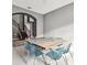 Dining room with gray walls and wood look floors features a wood table with blue epoxy detail and clear chairs at 6317 Brevada Ln, Apollo Beach, FL 33572