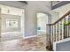 Spacious foyer showcasing wood-look tile floors and open access to a carpeted living room at 6317 Brevada Ln, Apollo Beach, FL 33572